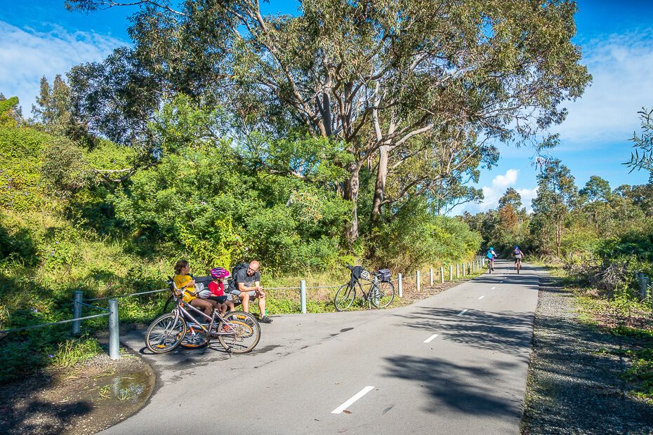Taking a rest sitting on a bench along the cycleway Taking a rest sitting on a bench along the cycleway